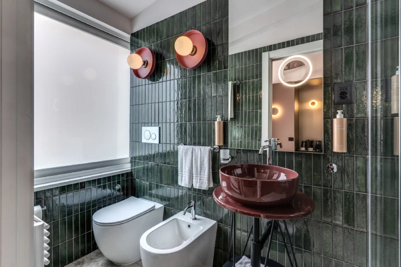 Deluxe bathroom with window, burgundy sink and green tiles near Palazzo Barberini in central Rome - Barberini 16, BZAR hotels in Rome