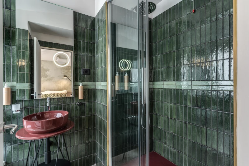 Modern bathroom with glass shower and green tiles in room near Palazzo Barberini Rome - Barberini 16, BZAR hotels in Rome